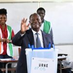 Ivorian President and presidential candidate for Rally of Houphouetists for Democracy and Peace (RHDP) Alassane Ouattara gestures after casting his ballot at the Lycee Saint-Marie polling station in Cocody, Abidjan, on October 25, 2025 during Ivory Coast's presidential elections. (Photo by SIA KAMBOU / AFP)